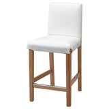 A white BERGMUND barstool with a light wood frame and backrest. It a comfortable, padded seat and supportive back.