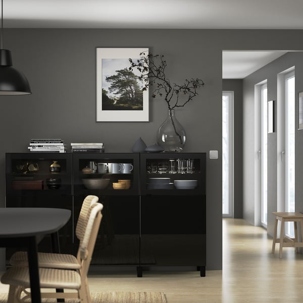 Modern dining room with BESTÅ sideboard, chairs, & table. Nature photo above, hallway leading to bright room with stool.