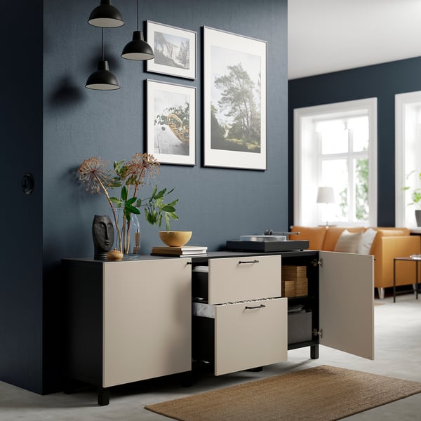 Modern sideboard with open drawers and cabinet, featuring adjustable shelves and decorative items on top.