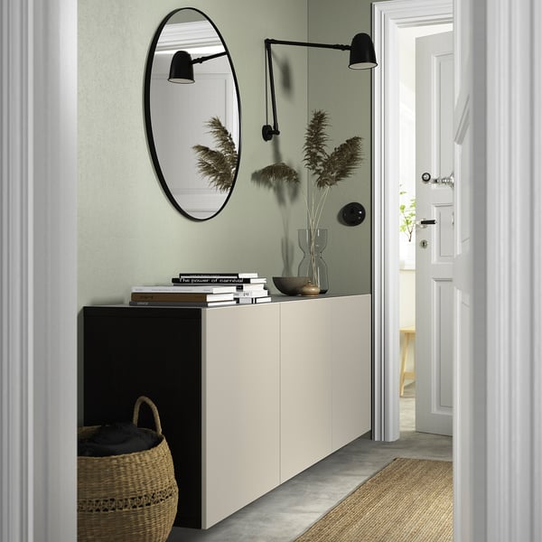 Modern entryway with BESTÅ sideboard, mirror, & decor.