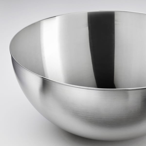 Stainless steel bowl, sleek and polished, reflects light, high quality, durable material.