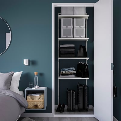 Modern BOAXEL closet with shelves, storage, clothes, bags, and bedside table with blanket.