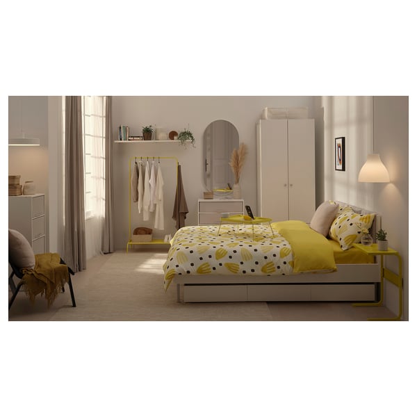 Yellow bedroom with BRUKSVARA bed, wardrobe, and natural light.