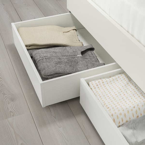 Two open storage boxes under bed for bedding, easy to access with castors.
