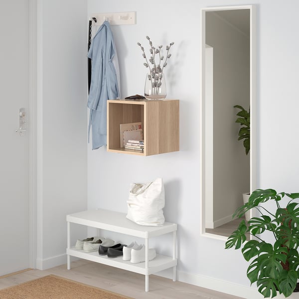 Minimalist entryway with EKET storage, mirror, and plant