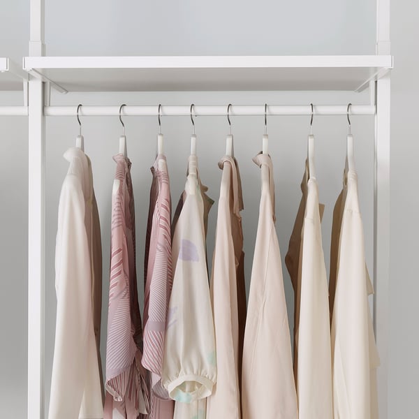 A wardrobe with adjustable shelves and hanging rails, demonstrating efficient use of vertical space with neatly organised clothes.
