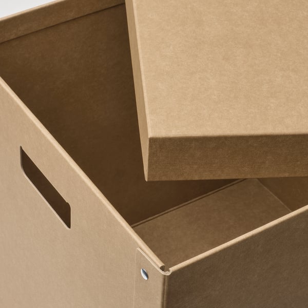 Stacked cardboard storage boxes with handles visible, showcasing sturdy construction and eco-friendly materials.