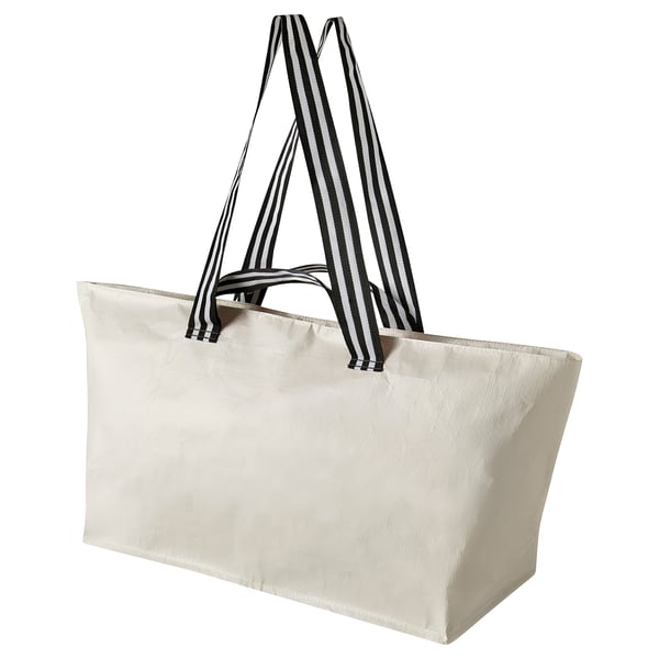 A black and white striped bag, resembling a rectangle with two handles, likely made of reusable fabric.