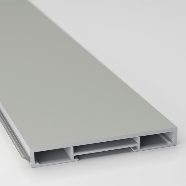 A close-up of a light grey kitchen cabinet plinth, showcasing its smooth paper foil surface and clean edges designed for a modern look.