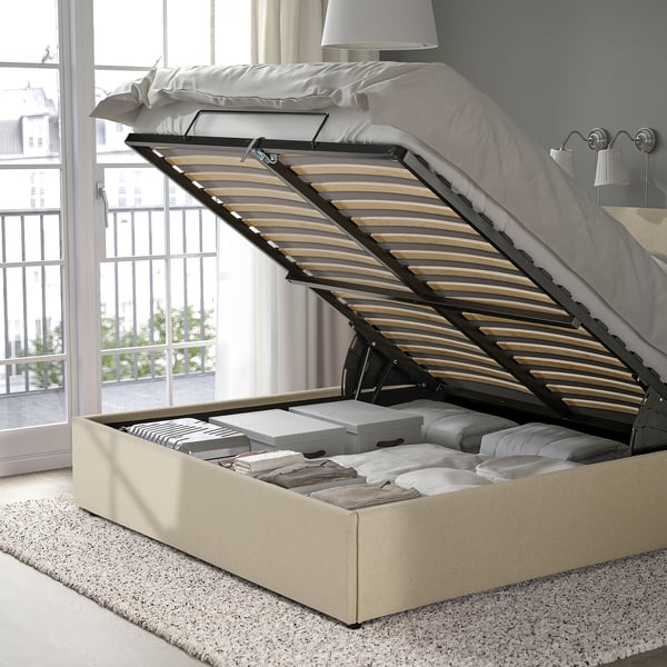 Bed with open storage, slatted base, and upholstered headboard.