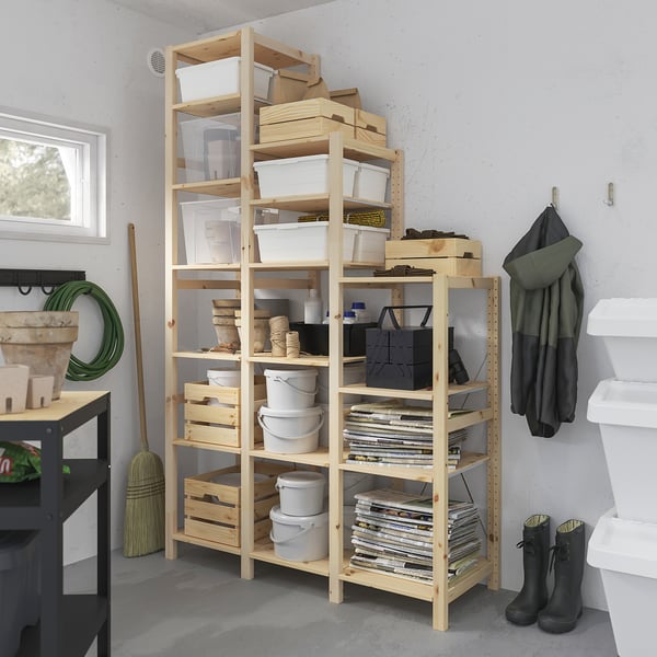 Wood IVAR shelf holds grey buckes, white boxes, tools. Tall, fits wall. ”