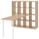 An ikea KALLAX shelving unit with a light wooden desk on top. It has multiple open cubes for storage.