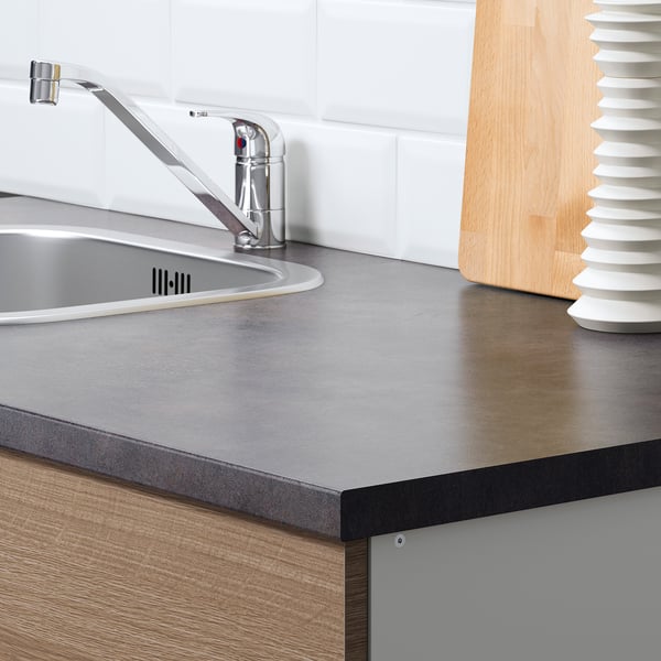 Kitchen counter with sink and tap, part of IKEAs KNOXHULT series. Easy to clean, durable worktop with integrated chopping board.
