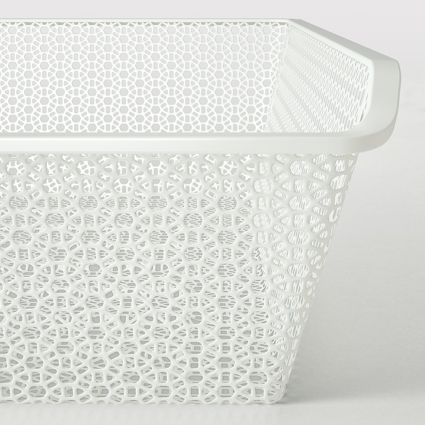 White decorative mesh basket for storage. Detailed geometric patterns. Sturdy and elegant, perfect for wardrobe organisation.