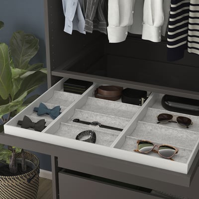 Drawer organiser with compartments for accessories and soft felt lining.