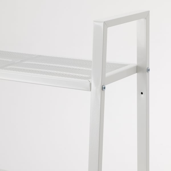 A close-up of a modern, white metal shelf with a perforated steel surface, secured by visible screws.