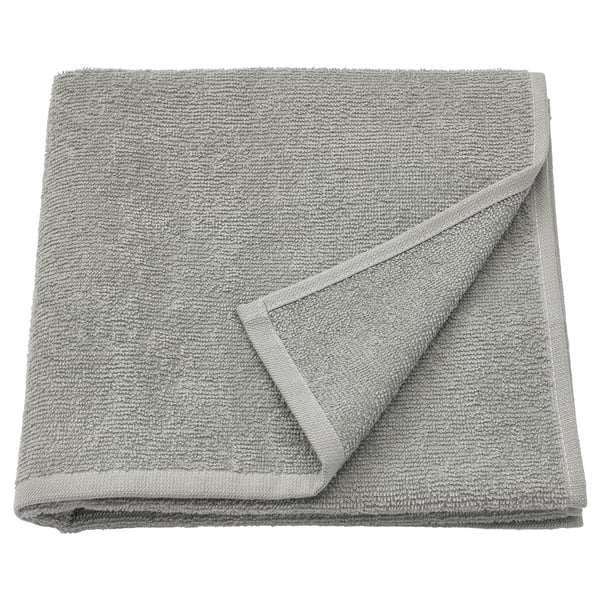 Folded grey LUDDVIAL cotton towel, soft, lightweight, neatly folded square shape with visible terry texture.