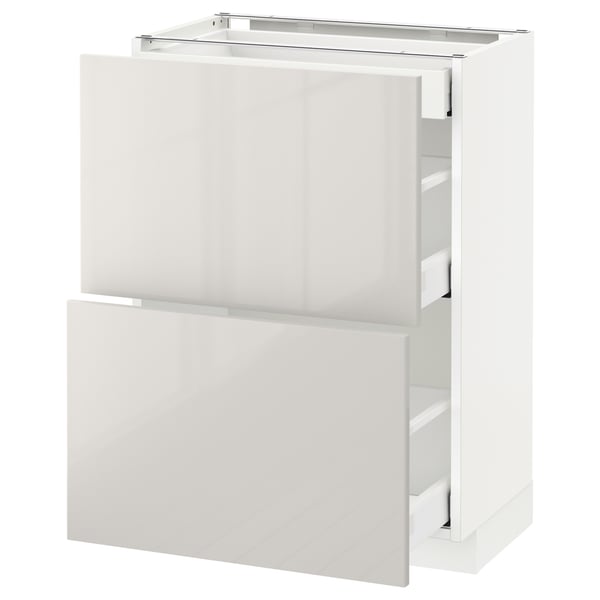 A white METOD kitchen cabinet with glossy, minimalist design and integrated drawers for storage.