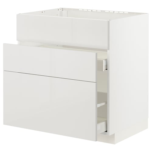 A white METOD kitchen cabinet with high gloss, smooth drawer fronts. It has a sleek, modern design with a clean, minimalist look.