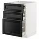 A white METOD kitchen cabinet with three black stained ash drawers featuring bevelled edges and a large door.