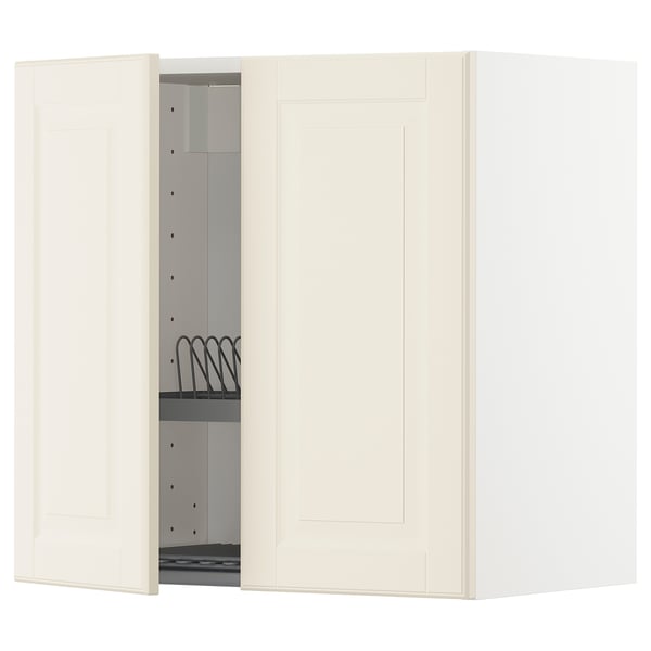 A white, wall-mounted ikea METOD kitchen cabinet with one door open, revealing an adjustable shelf and a black wire dish drainer.