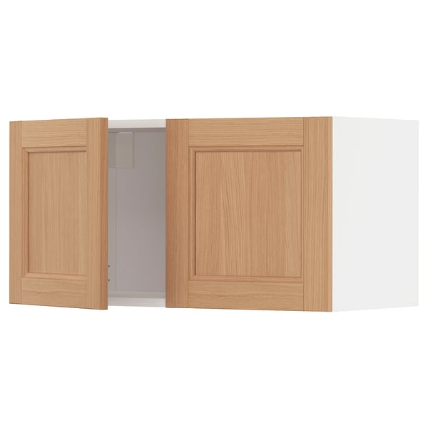 A light-colored wooden kitchen cabinet, featuring oak doors.