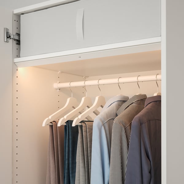 Modern wardrobe with built-in led light strip, illuminating clothes; automatically switches on and off when door opens or closes.