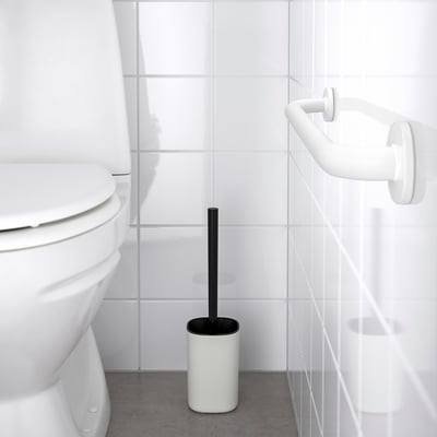 Minimalist white grab bar near toilet. OMTÄNKSAM series for support. Matte finish, sturdy steel, wall-mounted. Smaller than toilet.