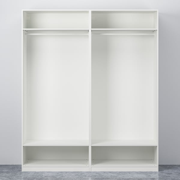 Two white PAX wardrobes with open, empty shelves and hanging rails against a plain wall.