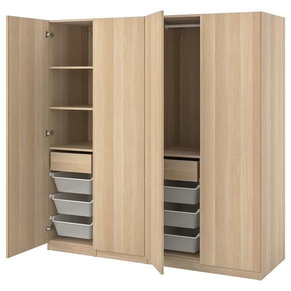 Light wood ikea PAX wardrobe with open drawers and shelves showing mesh baskets.