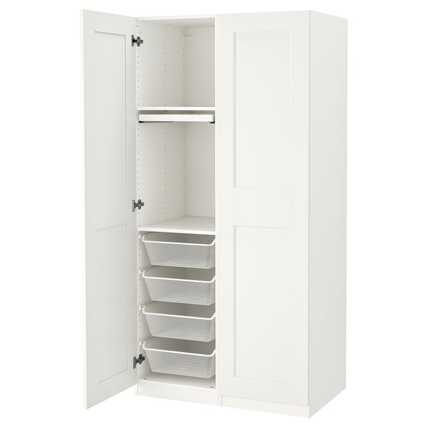 White PAX wardrobe, open revealing mesh baskets, drawers, and trouser hanger.