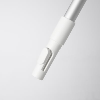 A sleek, white telescopic handle for cleaning, standing upright on a grey surface, showcasing its polished, durable design.