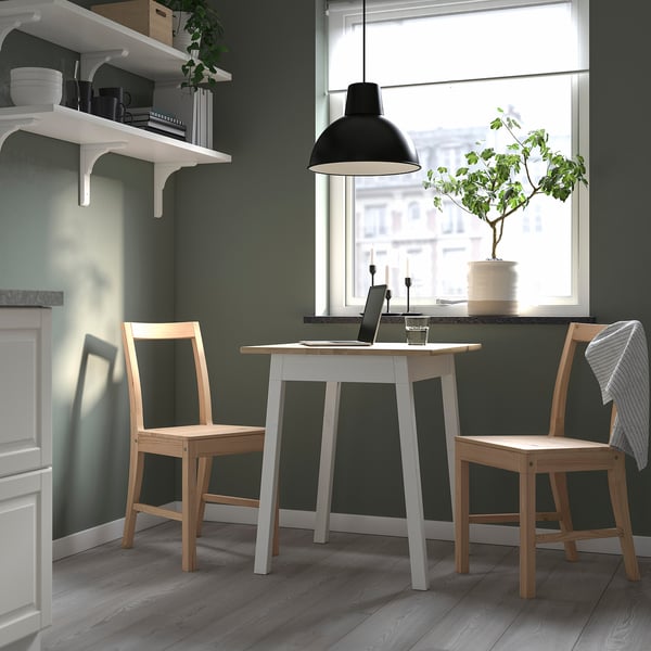 Cosy kitchen nook with PINNTORP table, laptops, and decor.