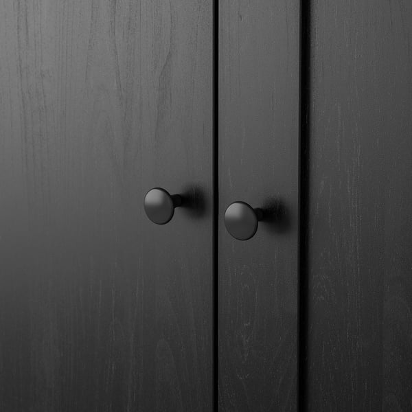 Black wooden cabinet with round knobs, sleek finish, showing sturdy construction.