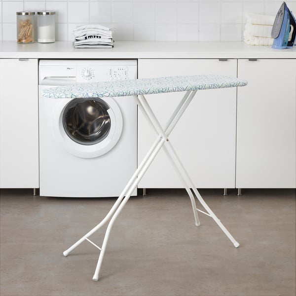 Laundry room with white washing machine, ironing board, and storage containers.
