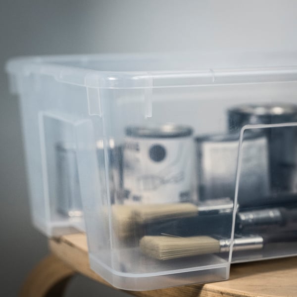 Clear plastic storage box, sturdy and transparent, showing contents inside, ideal for organising tools or supplies.