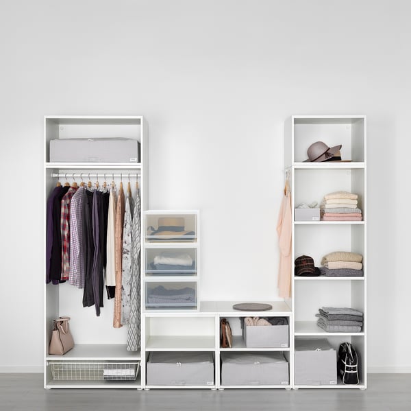 Modern closet with hangers, shelves, and drawers for neat clothing storage.