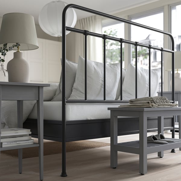 Minimalist bed frame with curved head/footboard, supportive slats, and storage space underneath. Tall design keeps textiles in place.