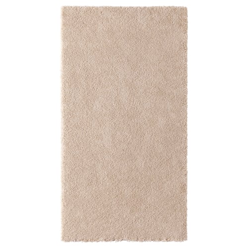 A beige-colored STOENSE rug with a soft, thick pile. Its rectangular and made from polyester and polypropylene, perfect for bedrooms.