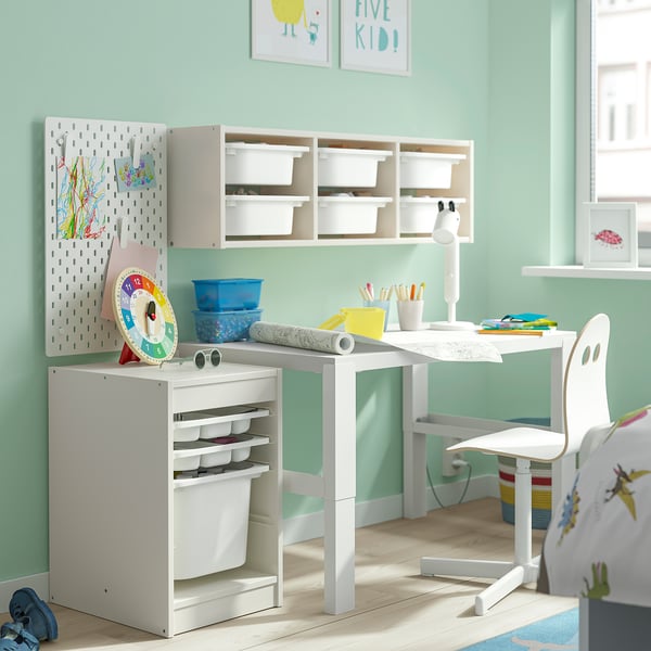 White TROFAST kids storage in room. Low, rectangular organiser with toy & art supply compartments.