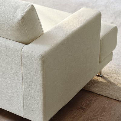 Light beige sofa, modern design, sturdy fabric, comfortable cushions, wooden legs, stylish.