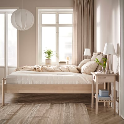 Bedroom with ÅKREHAMN bed, linen bedding, wooden floor, curtains, pendant lamp, side tables, rug, and plant.
