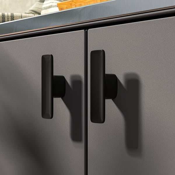 Modern outdoor kitchen cabinet with sleek black handles and sturdy metal surface.