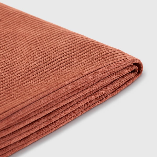Folded orange-brown recycled polyester fabric, neatly arranged, showcasing its smooth and uniform texture.