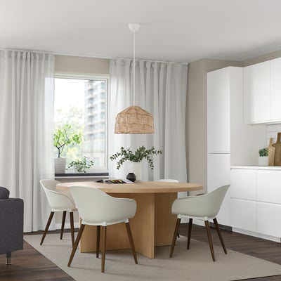 Modern dining area with sleek table, four chairs, pendant light, plants, and 3d-rendering.