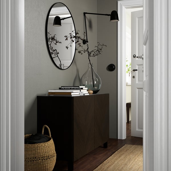 Modern entryway with BESTÅ sideboard, mirror, lights, vase, and basket.