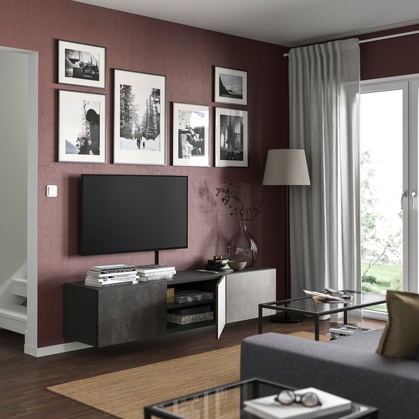 Modern living room with maroon walls, black BESTÅ tv bench, grey sofa, and large window.