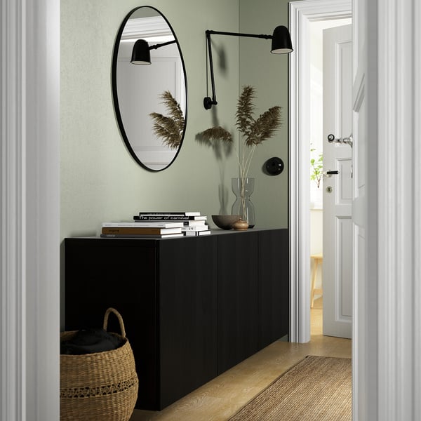 Black BESTÅ cabinet with mirror, books, grasses, basket