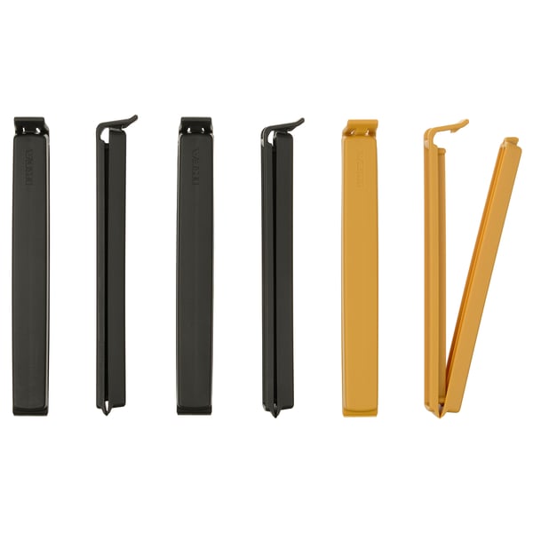 Six colourful sealing clips displayed; three black and three gold, rectangular shape with a lock mechanism, made of polypropylene plastic.