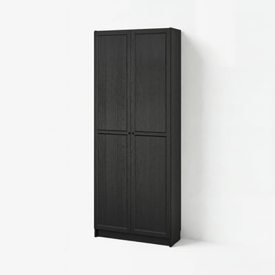 Black BILLY bookcase with vertical panels and two doors against white wall.